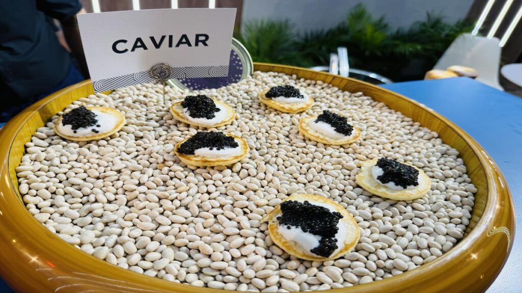 Blinis topped with cream cheese and black caviar at the ABS Foods Group stand