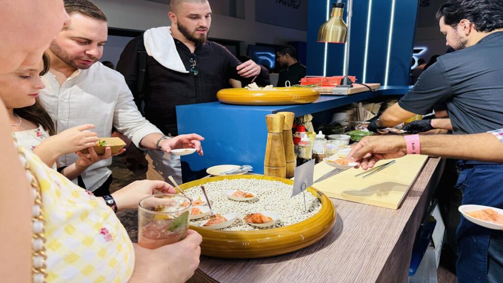 Guests enjoying food samples at a tasting station during the Casa de Campo Food & Wine Festival
