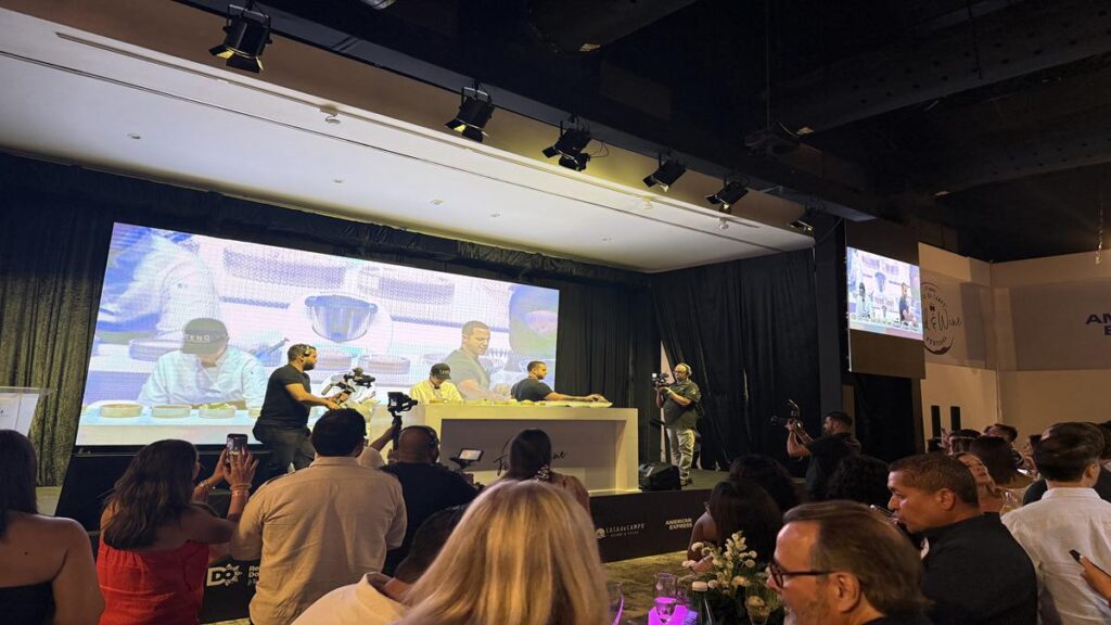 Festival guests watching a chef preparing food during a live cooking demonstration