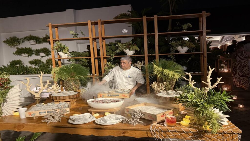 Seafood tasting station with decorative coral, fresh seafood displays and mist at Dinner Under the Stars