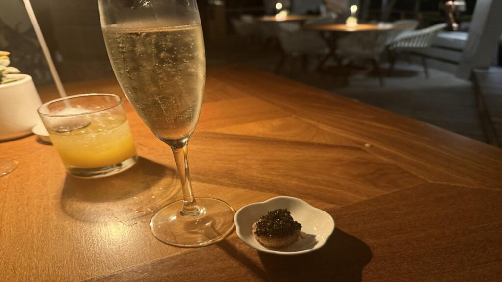 Glass of prosecco with a small caviar appetizer at Casa de Campo Dinner Under the Stars