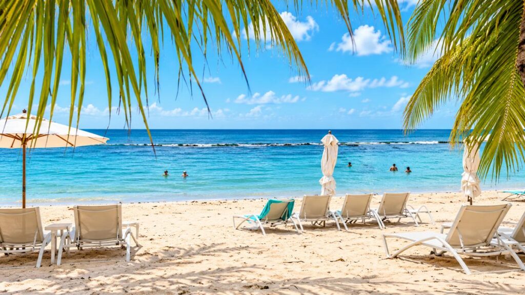 Minitas Beach at Casa de Campo Resort in La Romana, Dominican Republic, with turquoise water, palm trees and beach loungers.