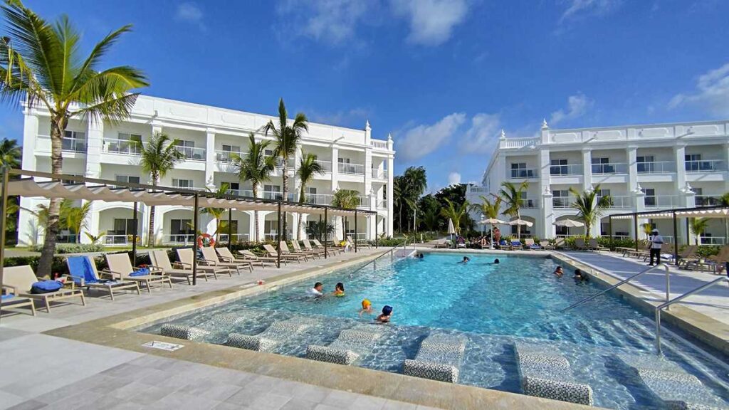 Hotel swimming pool with surrounding lounge chairs