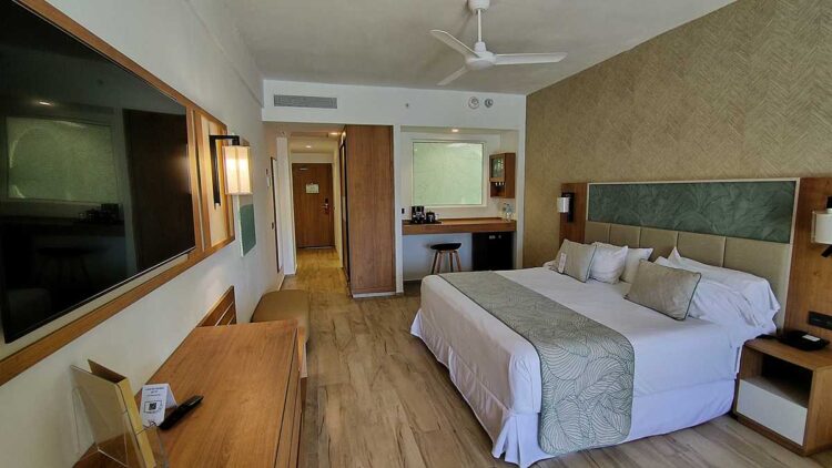The modern hotel room with king-size bed at Riu Palace Bavaro