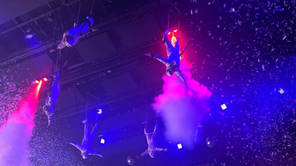 Acrobatic dance performance under colorful lights at Coco Bongo Punta Cana.