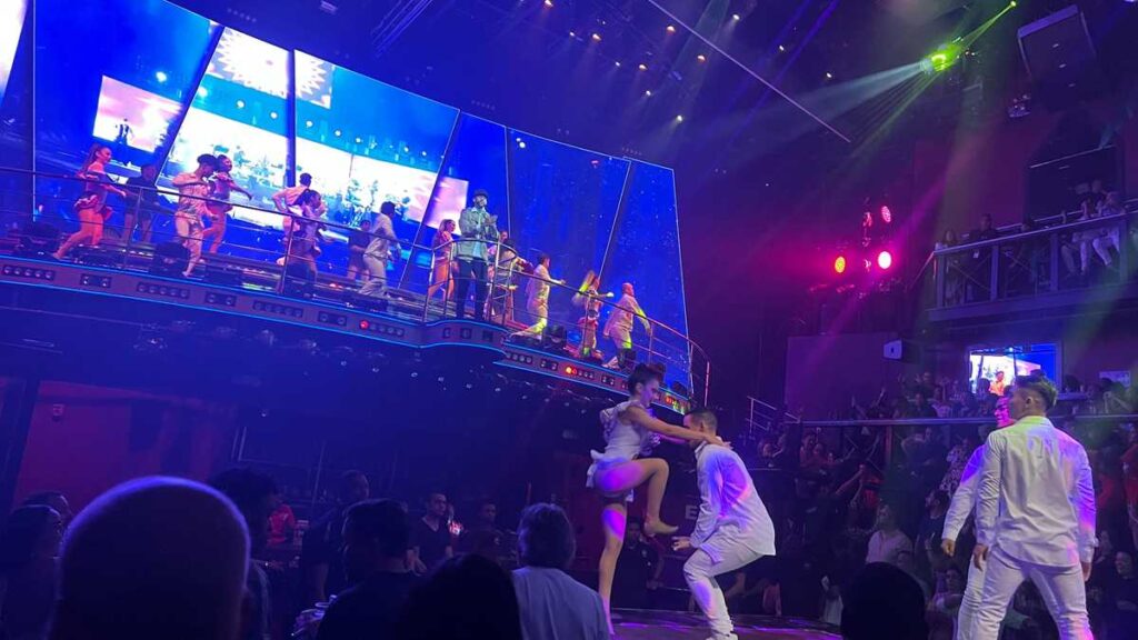 Energetic nightclub scene with performers at Coco Bongo in the Caribbean.