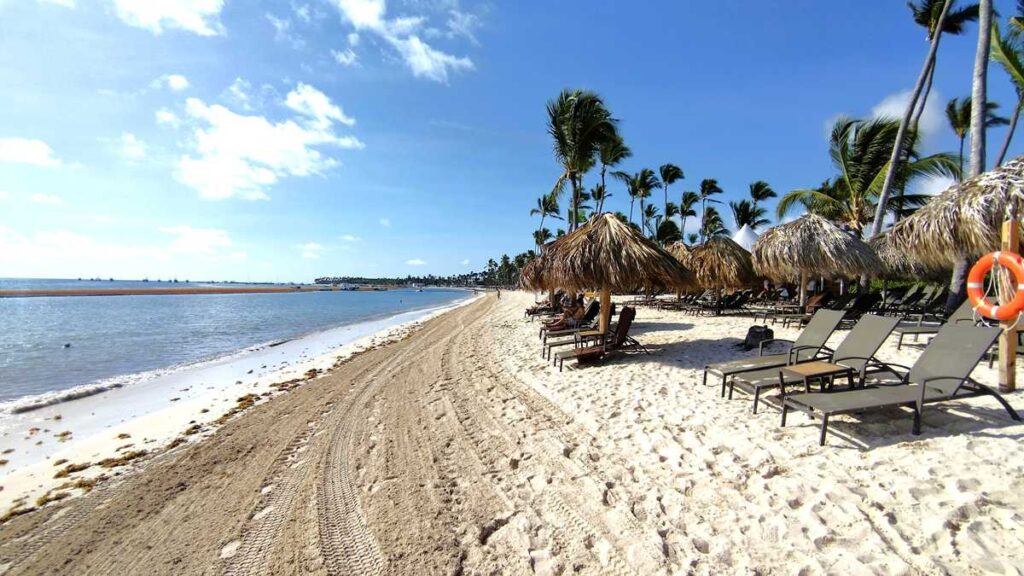 A wide beach at Dreams Flora Resort with soft sand and tropical scenery